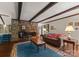 Living room with a stone fireplace, wooden beams, hardwood floors, and neutral colored walls at 4417 Walter Nelson Rd, Mint Hill, NC 28227