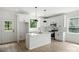 Bright kitchen with white cabinets, stainless steel appliances, island and wood floors at 4541 Kings Ct, Hickory, NC 28602
