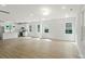 Open-concept living space with wood floors merges into a modern, white kitchen at 4541 Kings Ct, Hickory, NC 28602