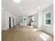 Open floor plan with hardwood floors connecting the living space to a modern kitchen with stainless appliances at 4541 Kings Ct, Hickory, NC 28602