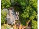 Aerial view of property showcasing the home, deck, patio, playground, and lush landscaping at 4622 Cotton Creek Dr, Charlotte, NC 28226