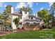 Spacious backyard featuring a deck, patio area, playset, and well-manicured lawn at 4622 Cotton Creek Dr, Charlotte, NC 28226