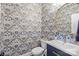 Stylish half bathroom with floral wallpaper, gold mirror, and navy blue vanity at 4622 Cotton Creek Dr, Charlotte, NC 28226
