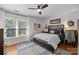 Comfortable bedroom with a wooden bed frame, hardwood floors, and natural light from the window at 4622 Cotton Creek Dr, Charlotte, NC 28226