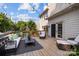 Inviting wooden deck with stylish outdoor seating, string lights, and serene backyard views at 4622 Cotton Creek Dr, Charlotte, NC 28226