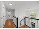 Hallway with staircase, wood floors, and an open view to the front door at 4622 Cotton Creek Dr, Charlotte, NC 28226