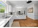 Spacious kitchen features white cabinets, marble countertops, hardwood floors, and stainless steel appliances at 4622 Cotton Creek Dr, Charlotte, NC 28226
