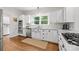 Bright kitchen featuring white cabinets, stainless steel appliances, and hardwood floors at 4622 Cotton Creek Dr, Charlotte, NC 28226