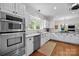 Bright kitchen featuring stainless steel oven and microwave, a large window, and hardwood floors at 4622 Cotton Creek Dr, Charlotte, NC 28226