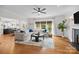 Bright living room with hardwood floors, fireplace, and large windows providing lots of natural light at 4622 Cotton Creek Dr, Charlotte, NC 28226
