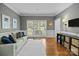 Bright living room featuring hardwood floors, large windows, and neutral-toned decor at 4622 Cotton Creek Dr, Charlotte, NC 28226