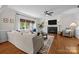 Cozy living room featuring a fireplace, plush seating, and a ceiling fan at 4622 Cotton Creek Dr, Charlotte, NC 28226