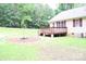 Charming home exterior with a spacious deck and landscaped yard, perfect for outdoor entertaining at 517 N Pine Ln, Wadesboro, NC 28170