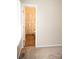 This bedroom doorway view features a bathroom with vinyl flooring, a shower/tub, and a decorative shower curtain at 517 N Pine Ln, Wadesboro, NC 28170