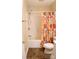 Bright bathroom with a tub/shower combo, a colorful shower curtain, and vinyl flooring at 517 N Pine Ln, Wadesboro, NC 28170