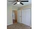 Neutral bedroom featuring a lighted ceiling fan, soft carpeting, and a double closet at 517 N Pine Ln, Wadesboro, NC 28170