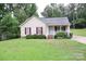 Charming single-story home with light siding, red shutters, and a well-maintained front yard at 517 N Pine Ln, Wadesboro, NC 28170