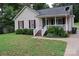 Well-kept one-story home with light siding, red shutters, and a manicured front lawn at 517 N Pine Ln, Wadesboro, NC 28170