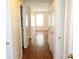 Inviting hallway featuring rich hardwood floors and neutral wall tones, leading to a bright living space at 517 N Pine Ln, Wadesboro, NC 28170