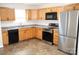 Modern kitchen featuring stainless steel appliances, wood cabinets, and durable countertops at 517 N Pine Ln, Wadesboro, NC 28170