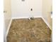 Compact laundry room with vinyl flooring and essential utility connections at 517 N Pine Ln, Wadesboro, NC 28170