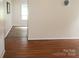 Bright living room featuring wood flooring and a view into adjacent room with neutral walls at 517 N Pine Ln, Wadesboro, NC 28170