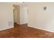 Spacious living room showcasing hardwood floors, neutral walls, and open access to adjacent rooms at 517 N Pine Ln, Wadesboro, NC 28170
