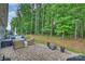 Backyard patio with brick pavers, outdoor seating, and a wooded view at 528 Sandbar Pt, Clover, SC 29710