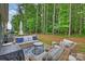 Relaxing backyard patio featuring outdoor seating, a rug, and wooded scenery at 528 Sandbar Pt, Clover, SC 29710
