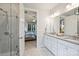 Bathroom showcasing double vanities, a shower, and doorway to a bedroom at 528 Sandbar Pt, Clover, SC 29710