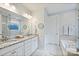 Bright bathroom with granite countertops, double sinks, and separate bathtub at 528 Sandbar Pt, Clover, SC 29710