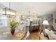 Well-lit kitchen with white cabinets, granite countertops, and a large island with seating at 528 Sandbar Pt, Clover, SC 29710