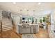 Open-concept kitchen with stainless steel appliances and view into the living and dining areas at 528 Sandbar Pt, Clover, SC 29710