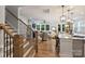 Open-concept living space with hardwood floors, staircase, and a view into the modern kitchen at 528 Sandbar Pt, Clover, SC 29710