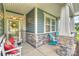 Charming front porch with cozy seating, stone accents, and decorative touches at 528 Sandbar Pt, Clover, SC 29710
