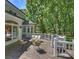 Charming back deck featuring outdoor seating and an adjacent structure surrounded by mature trees at 5308 Sunningdale Dr, Charlotte, NC 28277