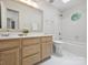 Bright bathroom features a large mirror, white tile, bathtub, and a skylight for natural light at 5308 Sunningdale Dr, Charlotte, NC 28277