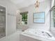 Bright bathroom features a walk in shower, soaking tub, and large windows at 5308 Sunningdale Dr, Charlotte, NC 28277
