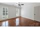 Spacious bedroom with hardwood floors, plantation shutters, and neutral decor at 5308 Sunningdale Dr, Charlotte, NC 28277