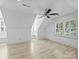Attic bonus room with a ceiling fan and window seats with shutters at 5308 Sunningdale Dr, Charlotte, NC 28277