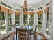Eat-in-kitchen features light-filled windows with backyard views and a classic chandelier at 5308 Sunningdale Dr, Charlotte, NC 28277