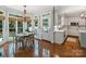 Bright breakfast nook features a round table, floor to ceiling windows and hardwood floors at 5308 Sunningdale Dr, Charlotte, NC 28277