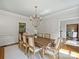 Dining room with classic decor featuring a chandelier, and access to other rooms at 5308 Sunningdale Dr, Charlotte, NC 28277