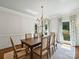 Dining room with a chandelier, and views of the beautifully landscaped backyard at 5308 Sunningdale Dr, Charlotte, NC 28277