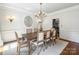 Elegant dining room features a wood table, chandelier, and classic wainscoting at 5308 Sunningdale Dr, Charlotte, NC 28277