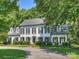 Stately two-story home with black shutters, mature landscaping and a curved driveway at 5308 Sunningdale Dr, Charlotte, NC 28277