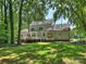 View of the exterior back of the house, featuring a deck, an enclosed gazebo, and large backyard at 5308 Sunningdale Dr, Charlotte, NC 28277