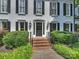 Charming front entrance featuring a black door with decorative glass and brick steps at 5308 Sunningdale Dr, Charlotte, NC 28277