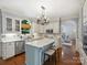 Well-appointed eat-in kitchen featuring stainless appliances, island seating, and natural light at 5308 Sunningdale Dr, Charlotte, NC 28277