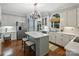 Bright kitchen with stainless steel appliances, large windows, and a center island with seating at 5308 Sunningdale Dr, Charlotte, NC 28277